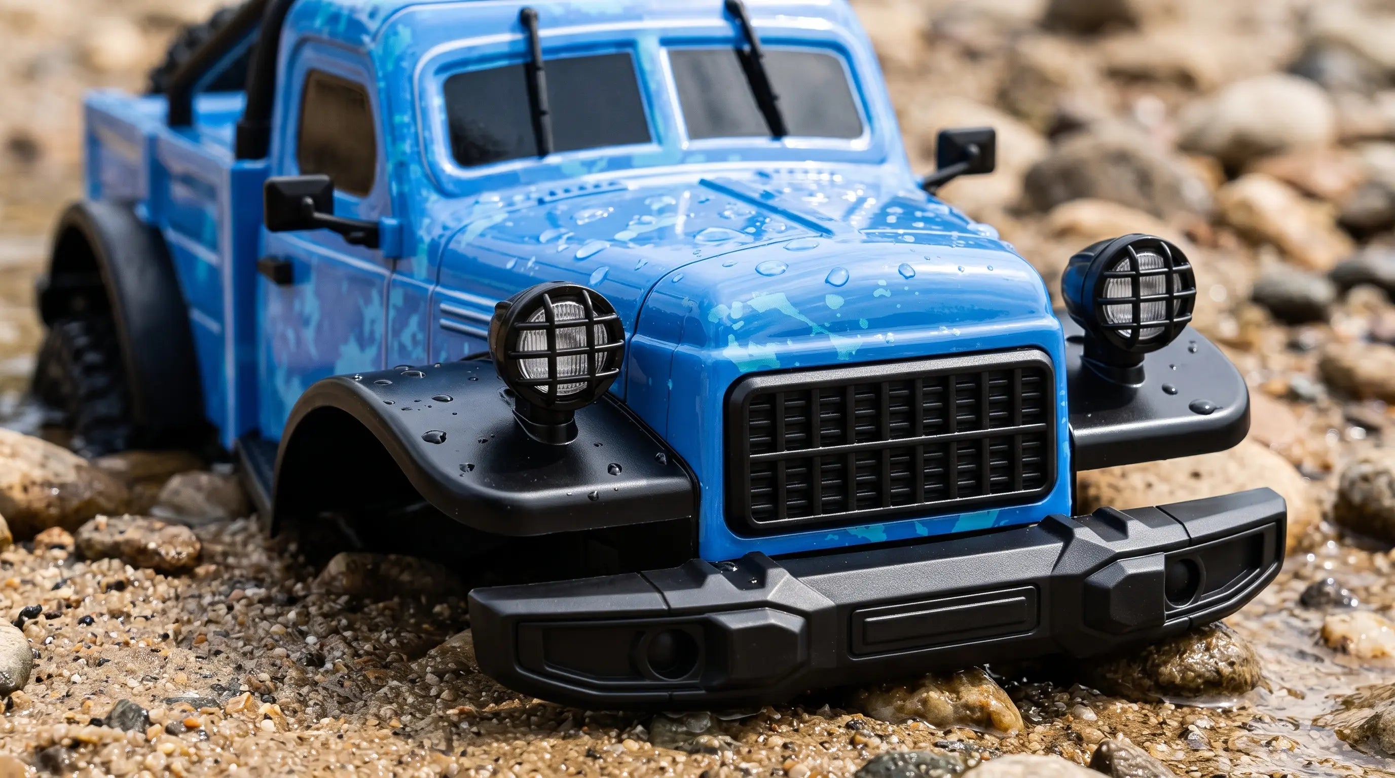Front grille detail of blue 1:16 RC truck showing cross-grid headlight covers and vintage bumper
